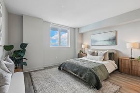 Miami apartment for rent - A bedroom with a large bed and a painting on the wall.