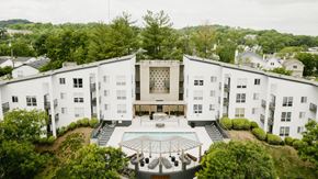 Nashville apartment for rent - an aerial view of a large white building with a courtyard and a pool