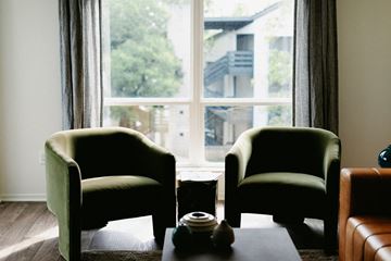 Nashville apartment for rent - two green chairs in front of a window in a living room