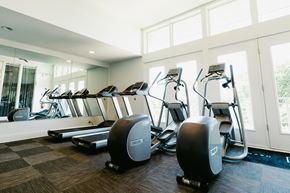 Nashville apartment for rent - a gym with cardio equipment on the floor and windows