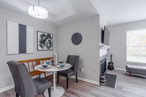 Cincinnati apartment for rent - A dining room with a table set for two and a guitar leaning against the wall.