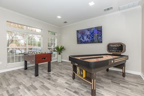 Euless apartment for rent - a games room with a foosball table and a ping pong table