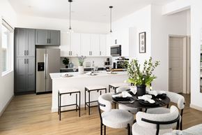 Omaha townhouse for rent - A modern kitchen with a dining table set for four.