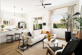 Prescott Valley apartment for rent - A modern living room with a white sofa, a coffee table, and a ceiling fan.