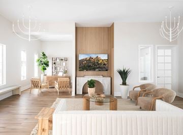 Prescott Valley apartment for rent - A living room with a large painting of a forest scene on the wall.