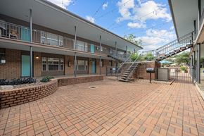 Austin apartment for rent - a brick courtyard with a staircase in front of a building