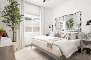 Omaha townhouse for rent - A bedroom with a large bed and a mirror on the wall.