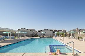Gilbert apartment for rent - A swimming pool with a hat and a towel on the side.