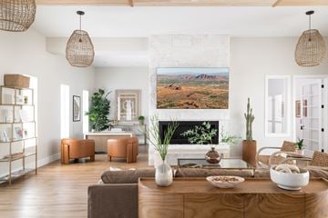 Gilbert apartment for rent - A living room with a large painting of a desert landscape on the wall.