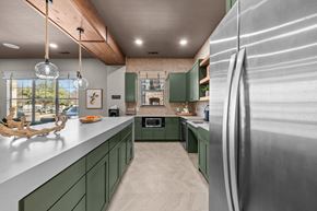 San Marcos apartment for rent - A modern kitchen with green cabinets and a stainless steel refrigerator.