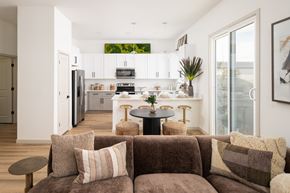 Casa Grande apartment for rent - A brown couch with a table in front of it and a kitchen in the background.