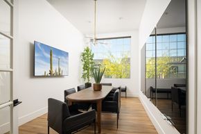 Litchfield Park apartment for rent - A modern dining room with a wooden table and chairs.