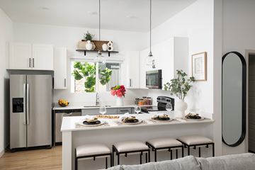 Phoenix apartment for rent - A modern kitchen with a dining table set for two.
