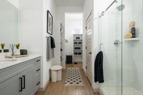Phoenix apartment for rent - A bathroom with a glass shower stall and a white sink.