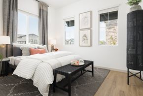 Queen Creek apartment for rent - A bedroom with a large bed and a black coffee table.