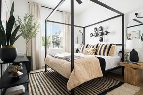 Surprise apartment for rent - A bedroom with a four poster bed and a cactus on the side table.