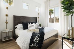 Buckeye apartment for rent - A bedroom with a large bed and a plant on the side table.