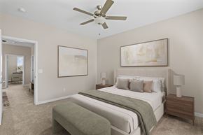 Phoenix apartment for rent - A bedroom with a large bed and a ceiling fan.