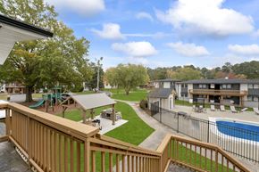 Durham apartment for rent - a view of the backyard of a community with a pool and buildings