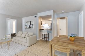 Arlington apartment for rent - A living room with a couch, coffee table, and a dining table.
