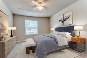 Arlington apartment for rent - A bedroom with a large bed and a ceiling fan.