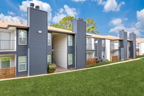 Arlington apartment for rent - a row of townhomes with gray roofs and green grass