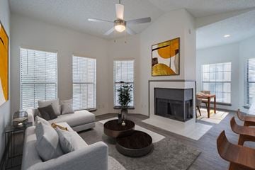 Dallas apartment for rent - a living room with a couch and a table and a fireplace