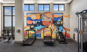 Phoenix apartment for rent - A gym with treadmills and a colorful mural on the wall.