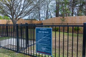 Summerville apartment for rent - a sign in front of a fence with a pool behind it