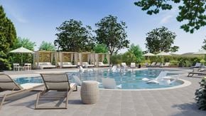 Gallatin townhouse for rent - A large outdoor swimming pool surrounded by lounge chairs and umbrellas.