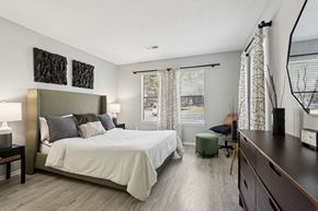 Marietta apartment for rent - A bedroom with a large bed and a window with curtains.