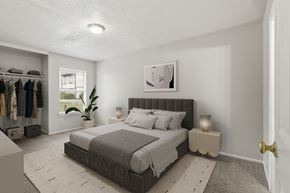 Stephenville apartment for rent - A bedroom with a large bed and a clothing rack.