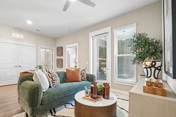 Austin apartment for rent - A living room with a green couch and a coffee table.