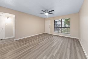 Dallas apartment for rent - a bedroom with a ceiling fan and a window