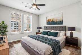 Gallatin townhouse for rent - A bedroom with a bed, nightstands, and a ceiling fan.