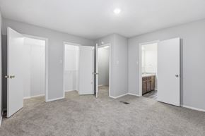 Stephenville apartment for rent - A spacious room with white walls and carpeted floor.