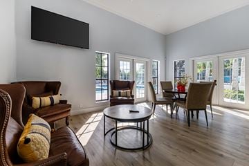 North Lauderdale apartment for rent - A living room with a brown leather couch and a black television mounted on the wall.