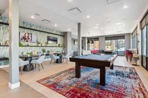 Denver apartment for rent - A room with a pool table and a TV mounted on the wall.