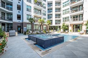 Dallas apartment for rent - A pool surrounded by apartment buildings.