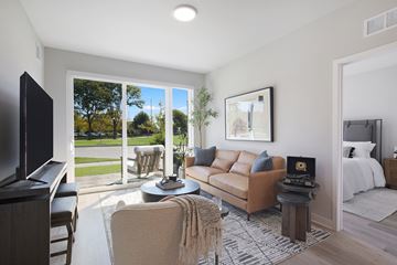 Skokie townhouse for rent - A living room with a brown couch and a television.
