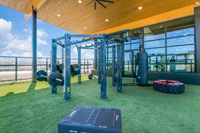 Lewisville apartment for rent - A gym with a green floor and a wooden ceiling.