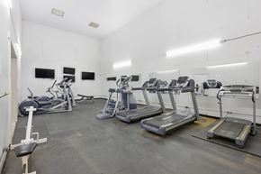 Stephenville apartment for rent - A gym with treadmills, exercise bikes, and weight machines.