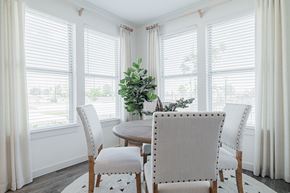 Houston apartment for rent - a dining room with white walls and a wooden table with white chairs