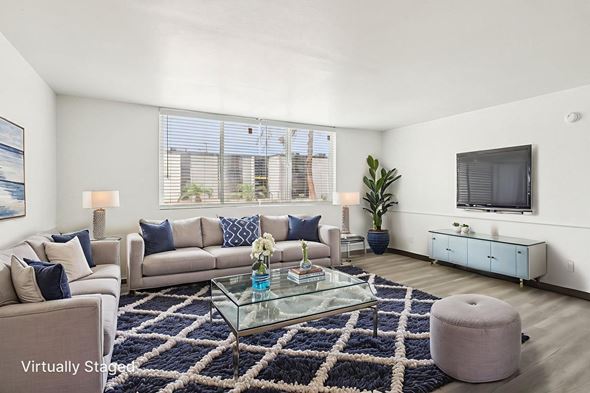 North Las Vegas apartment for rent - A living room with a glass coffee table and a large window.