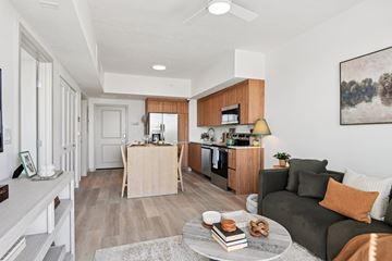 Fort Worth apartment for rent - A modern living room with a grey sofa and a wooden coffee table.
