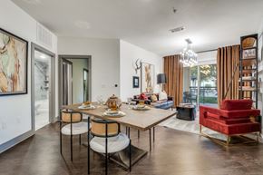 Dallas apartment for rent - A dining room with a table set for two and a red chair.