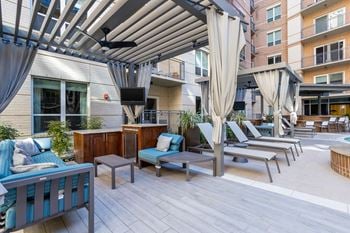 Private pool cabanas each furnished with a safe, tv, ceiling fan, and mini refrigerator