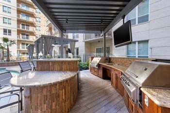 Outdoor kitchen with 3 gas grills and prep stations