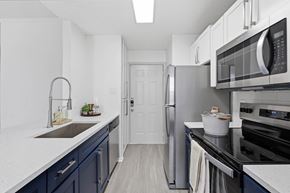 Irving apartment for rent - A kitchen with a white counter top and a sink.