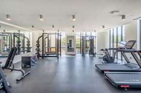 Durham apartment for rent - a gym with treadmills and other exercise equipment in a building with windows
